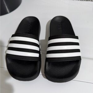 Black and white adidas slides